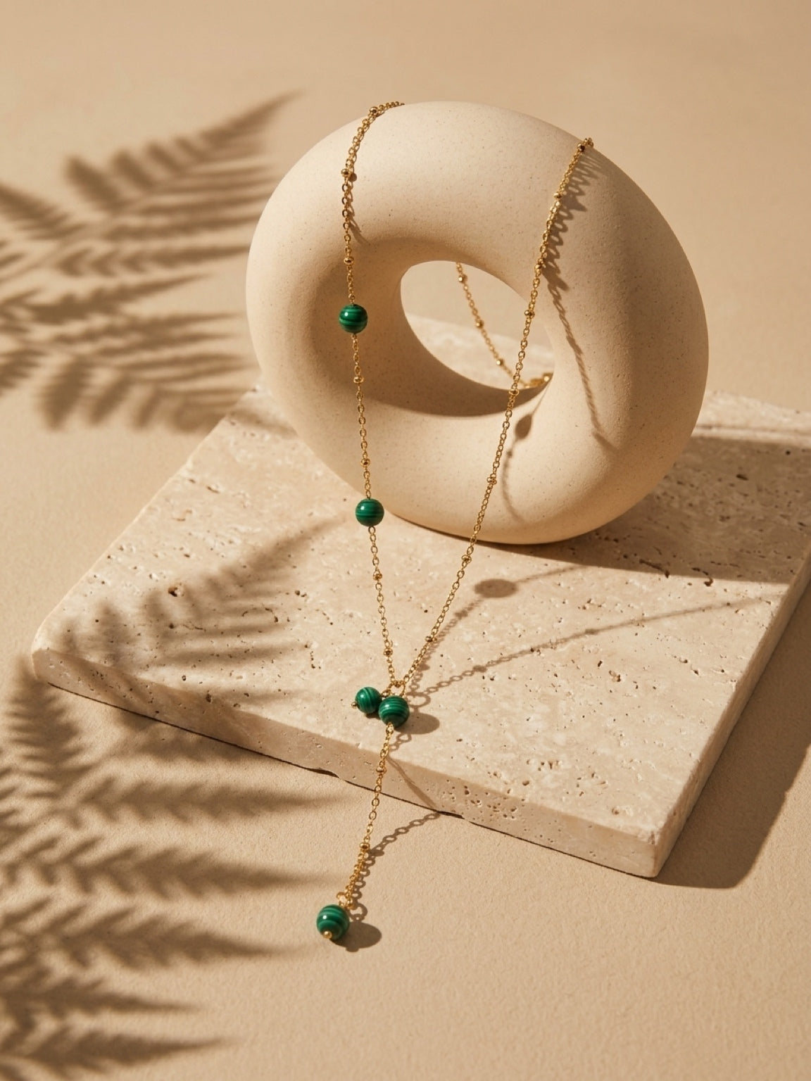 Malachite bead drop necklace on a gold tone chain