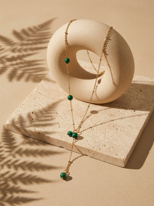 Malachite bead drop necklace on a gold tone chain