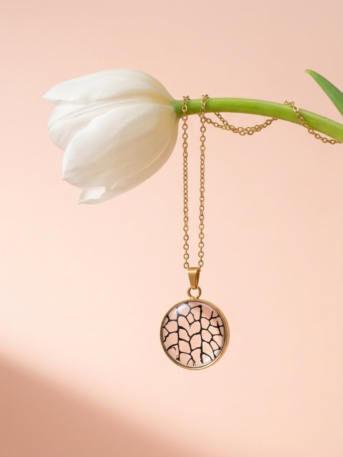 Black sea fan circle pendant on a gold plated chain