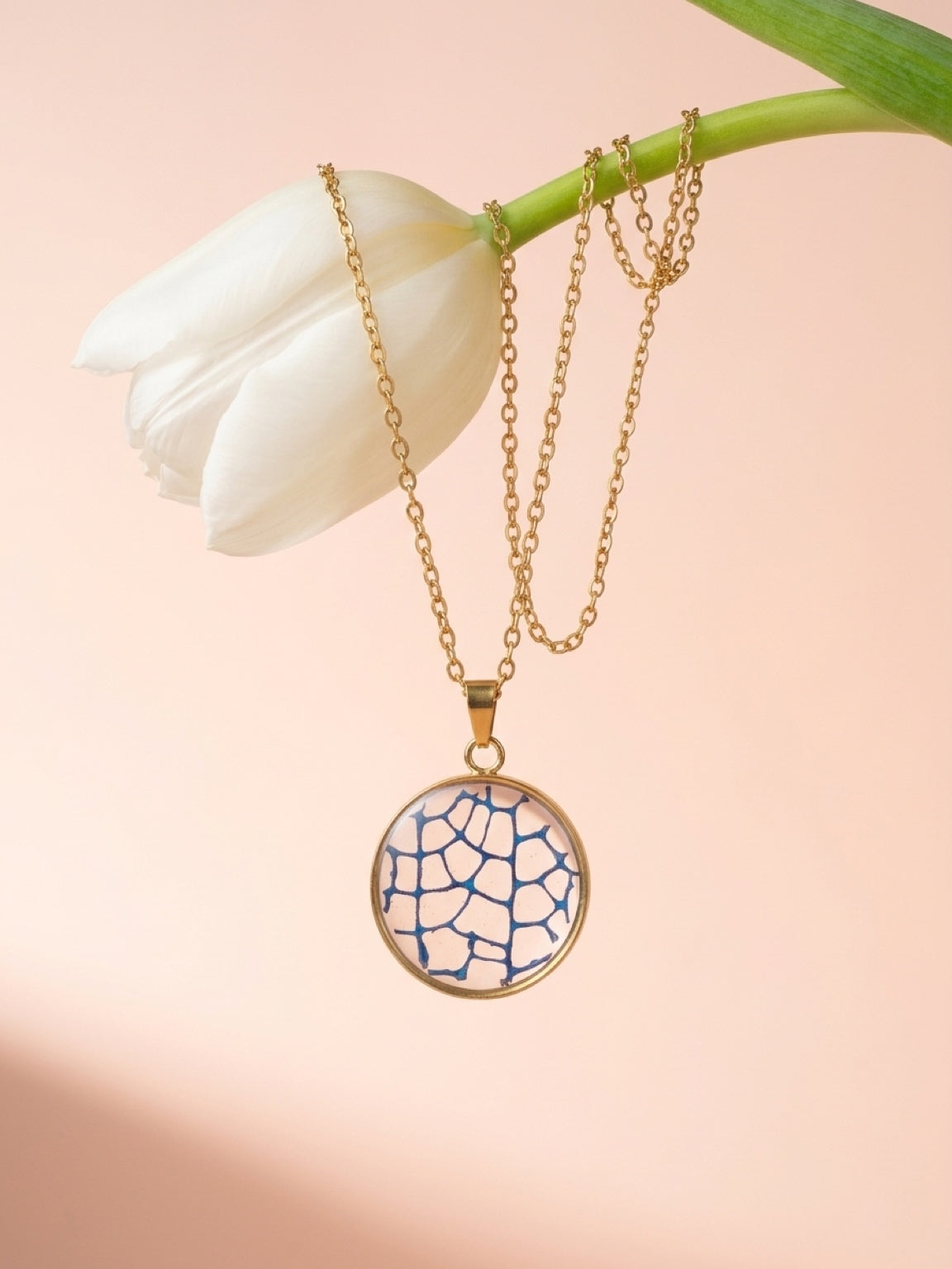 Blue sea fan circle pendant on a gold plated chain